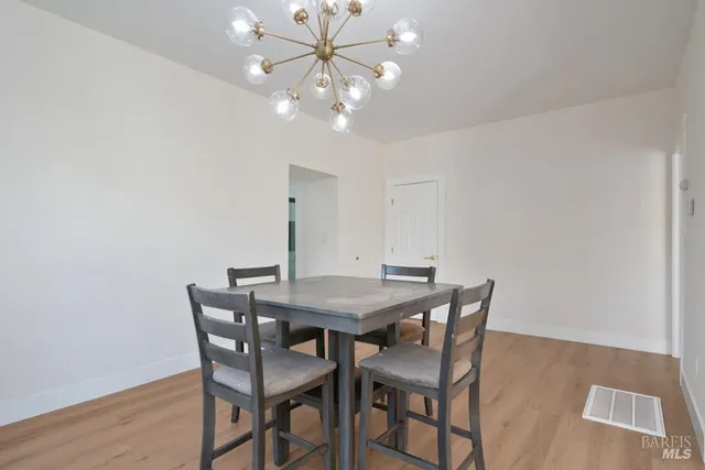 a view of a dining room with furniture and chandelier