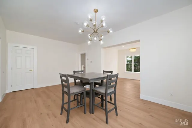 a kitchen with a sink cabinets and wooden floor