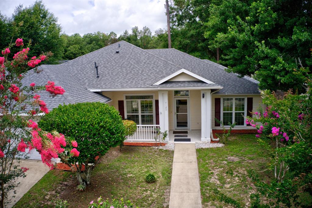 a house with flowers in front of it