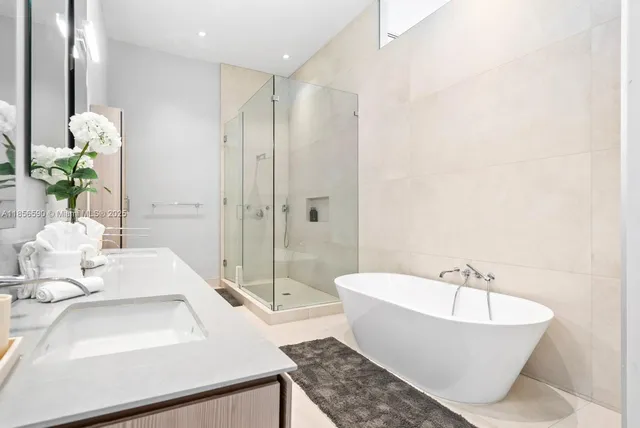 a bedroom with a bed and glass door