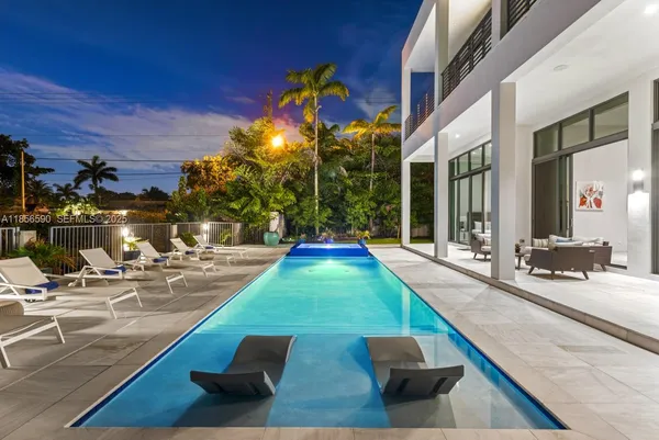 a view of swimming pool with outdoor seating