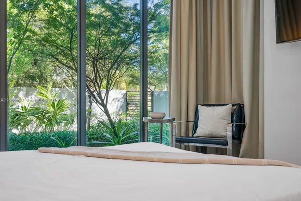 a bedroom with a bed and a view of lake