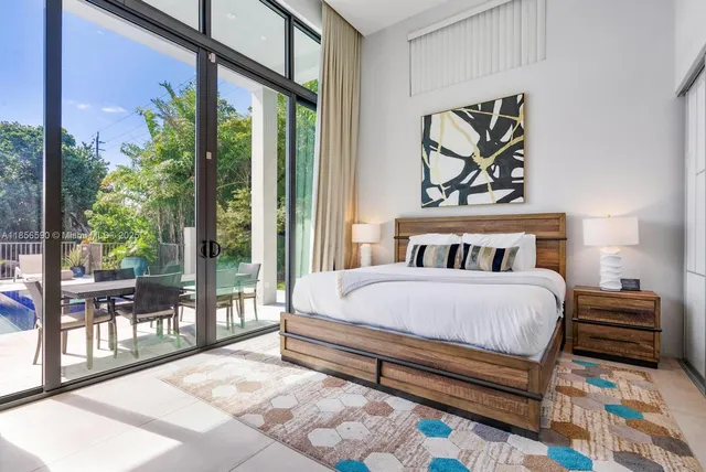 a living room with furniture and large windows