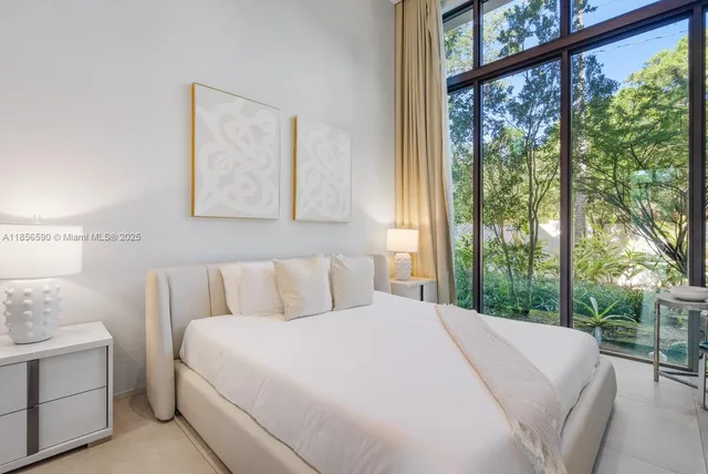 a spacious bedroom with a bed and a couch