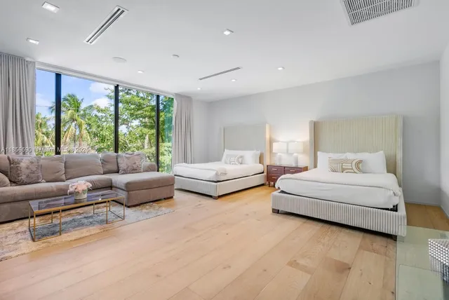 a spacious bedroom with a bed and a large window