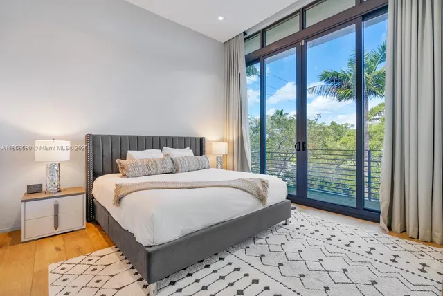 a bedroom with a bed and a painting on the wall