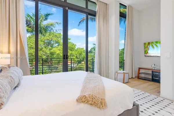 a front view of a building with a garden and plants