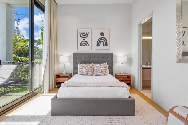 a view of a patio with dining table and chairs with plants and palm trees