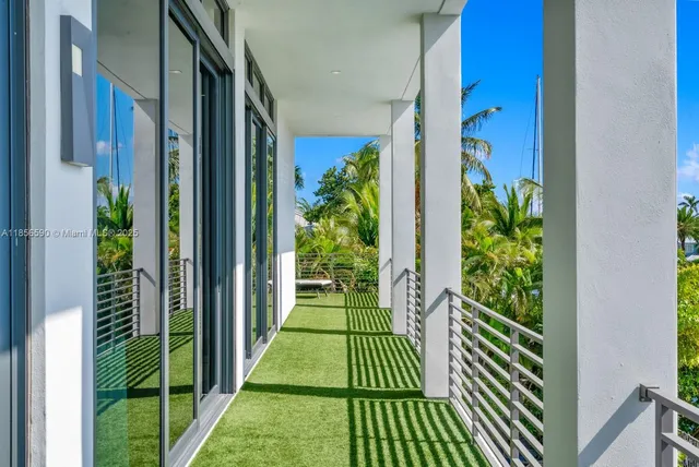 a view of a patio with couches and table and chairs next to yard