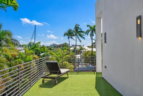 a view of a house with swimming pool and sitting area