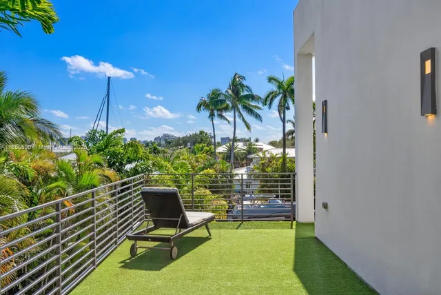 a view of a house with swimming pool and sitting area