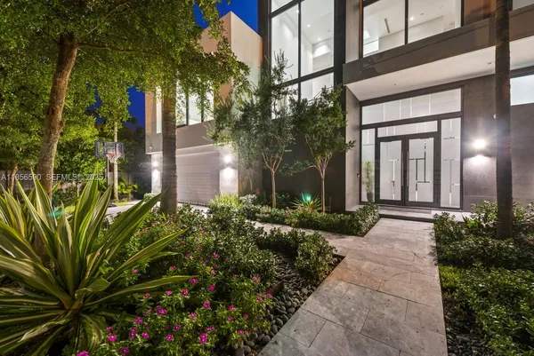 a view of a house with swimming pool and sitting area