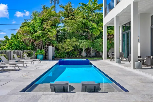 a view of a white house next to a yard