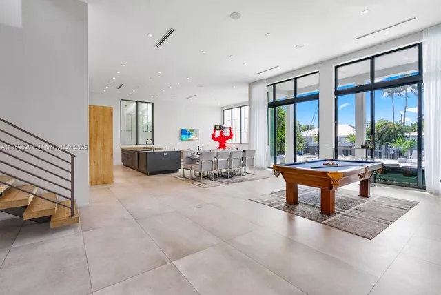a living room with furniture and a floor to ceiling window
