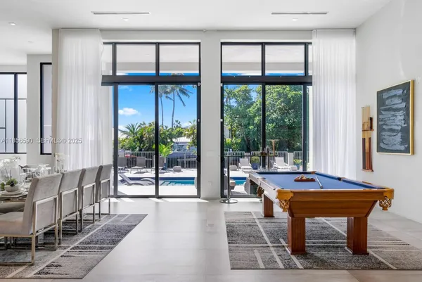 a room with furniture and large windows