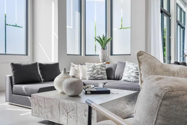 a living room with furniture and a large window