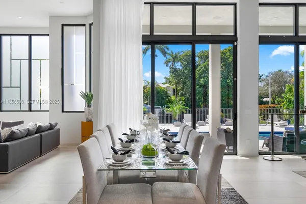 a living room with furniture and floor to ceiling windows