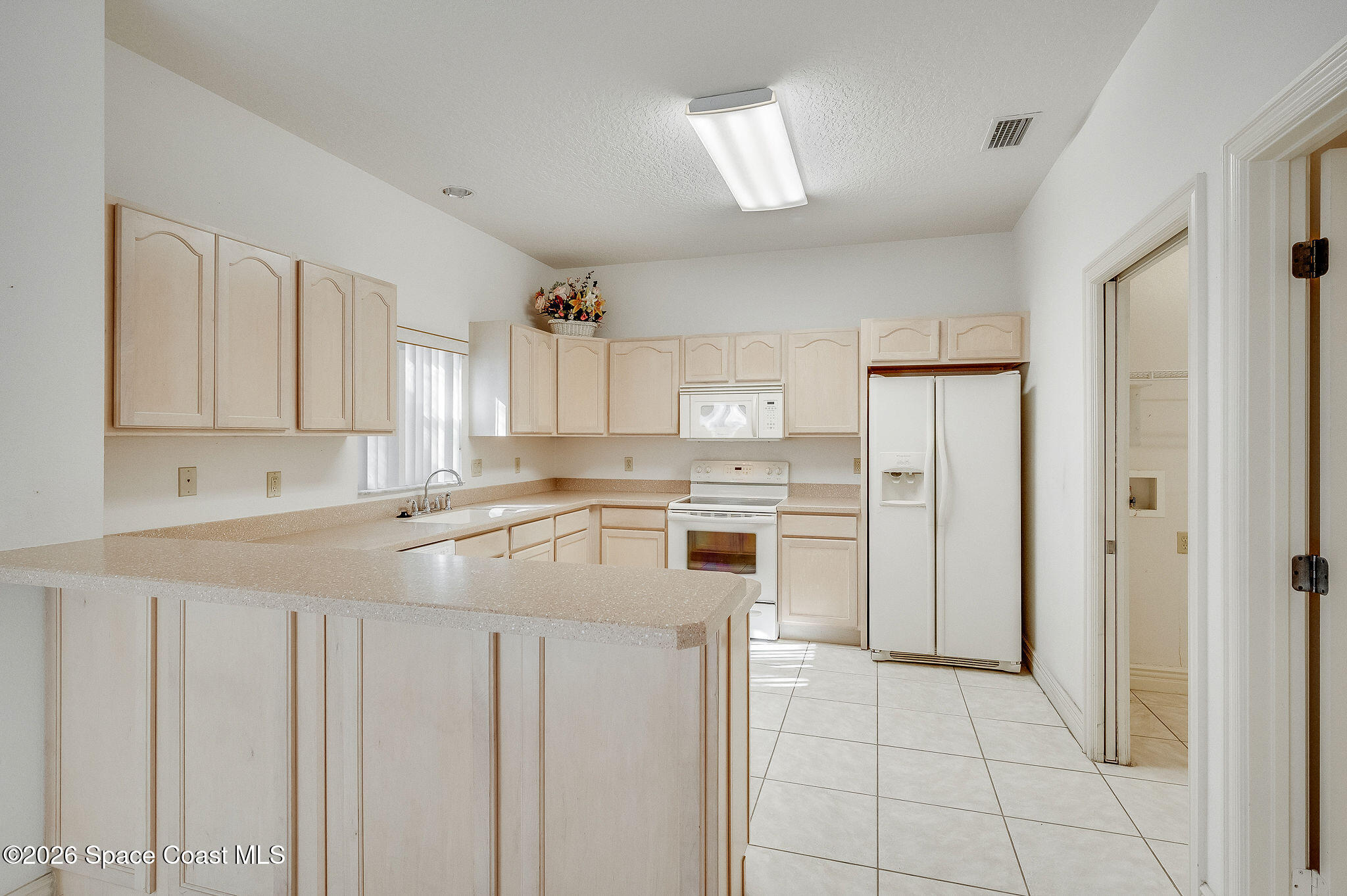 624 Cedar Side Circle Northeast Palm Bay, FL 32905 - Photo 10 of 35 a kitchen with cabinets and stainless steel appliances