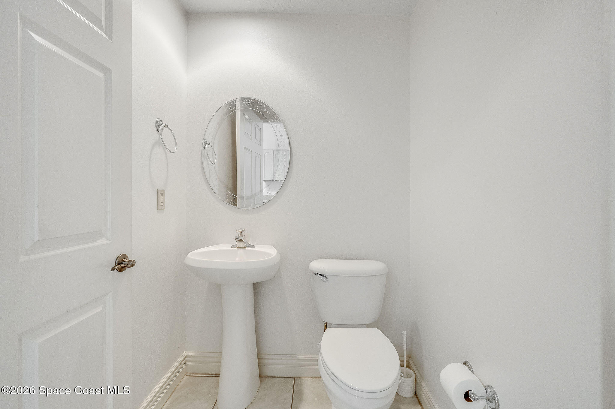 624 Cedar Side Circle Northeast Palm Bay, FL 32905 - Photo 13 of 35 a bathroom with a toilet a sink and mirror