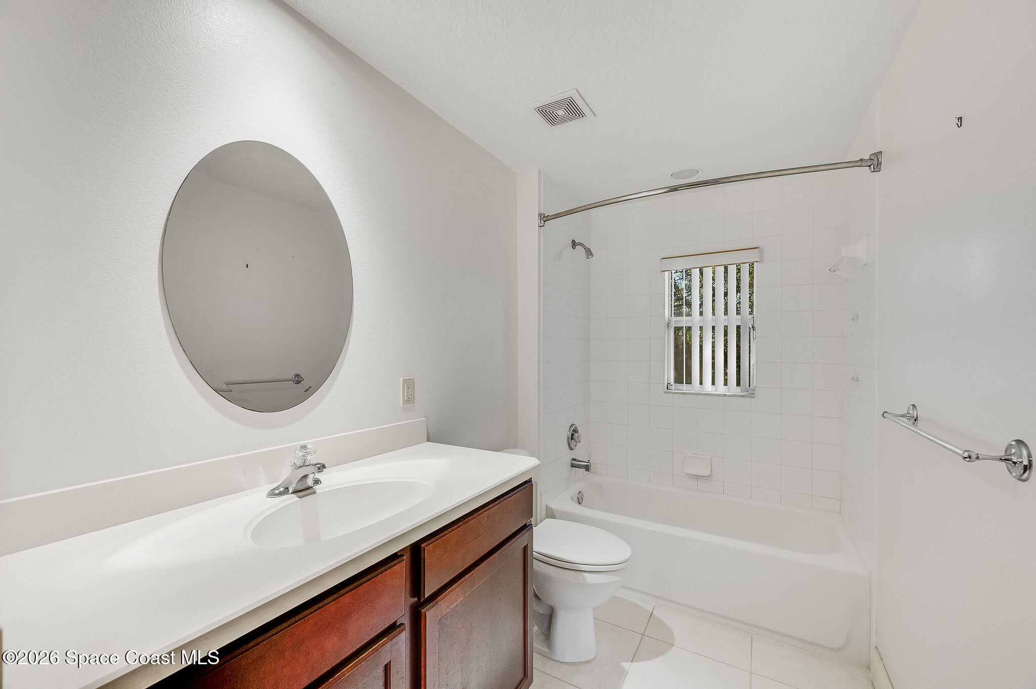 624 Cedar Side Circle Northeast Palm Bay, FL 32905 - Photo 26 of 35 a bathroom with a toilet a sink a mirror and bathtub