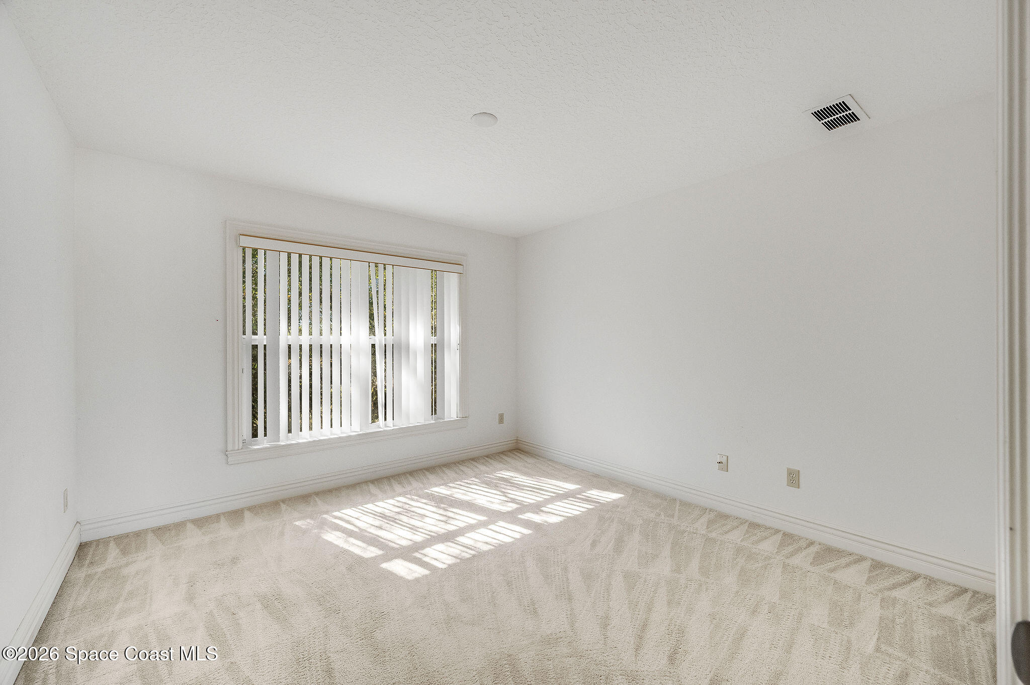 624 Cedar Side Circle Northeast Palm Bay, FL 32905 - Photo 27 of 35 a view of an empty room with a window