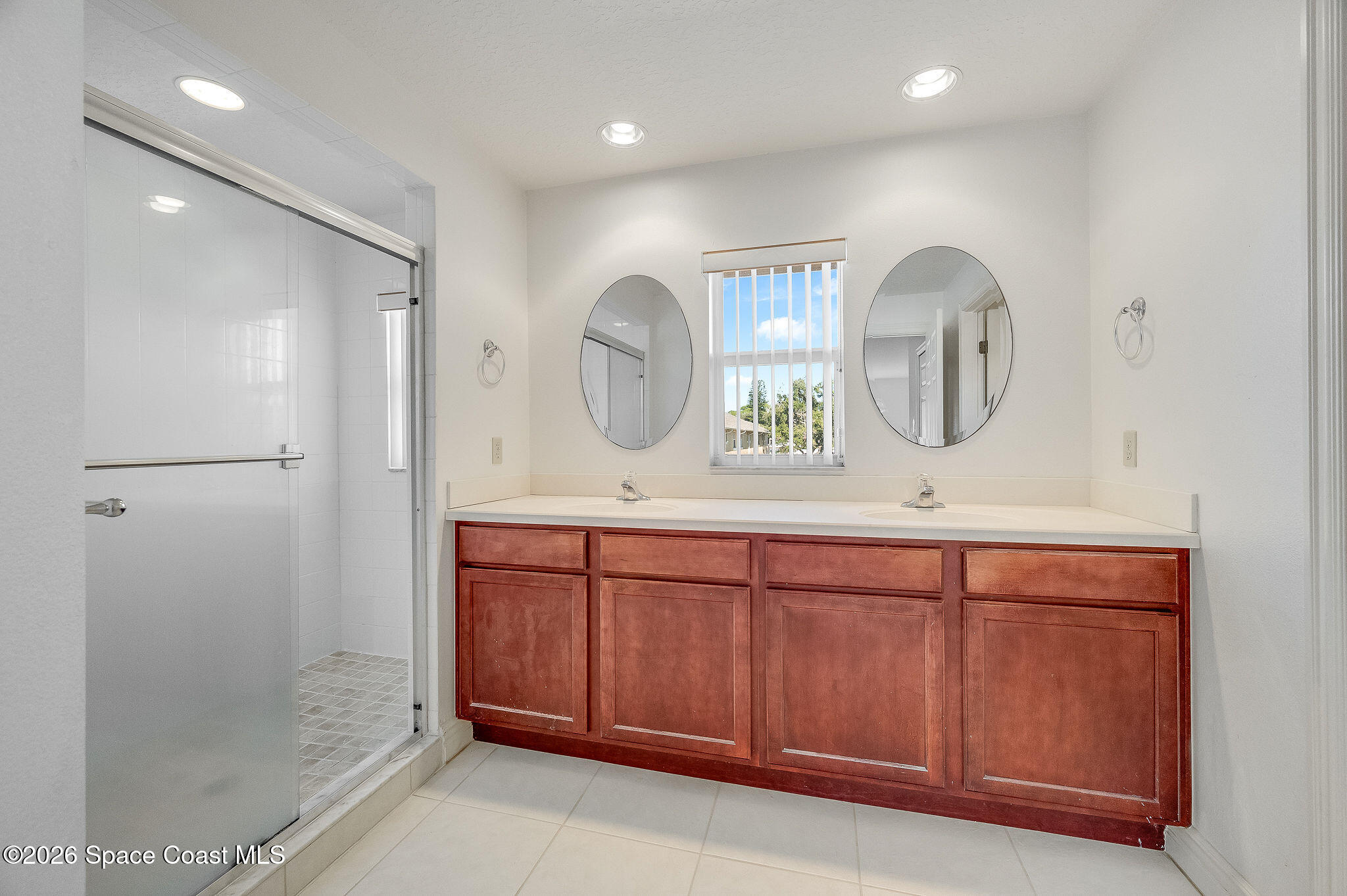 624 Cedar Side Circle Northeast Palm Bay, FL 32905 - Photo 3 of 35 a bathroom with a double vanity sink mirror and shower