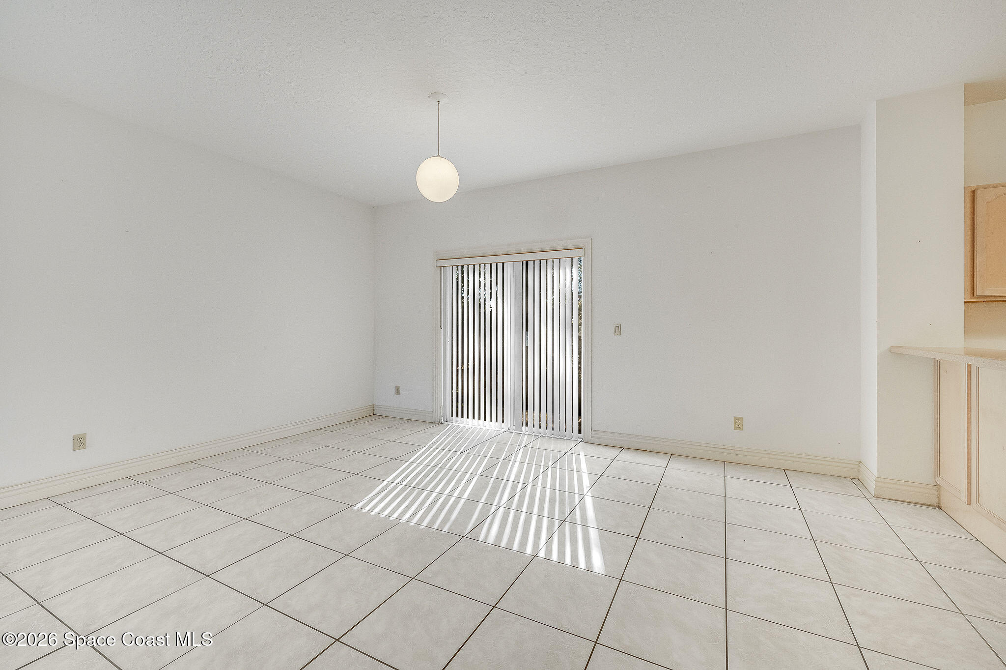 624 Cedar Side Circle Northeast Palm Bay, FL 32905 - Photo 9 of 35 an empty room with white walls and tiles