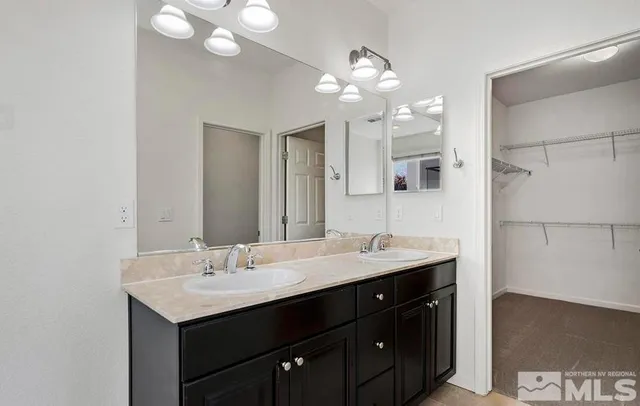 a bathroom with a sink double vanity and a mirror