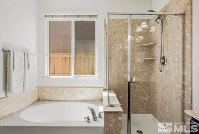 a white bath tub sitting next to a shower