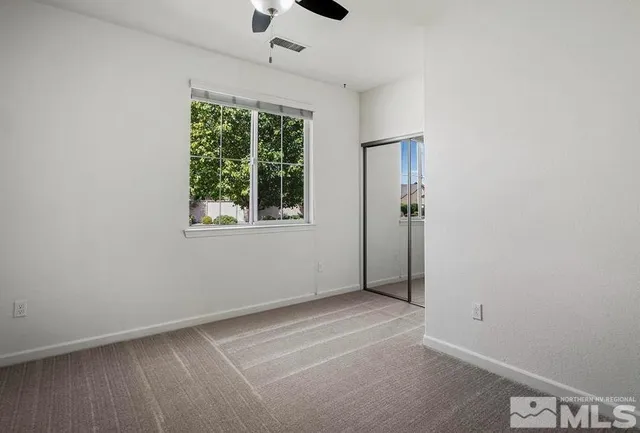 an empty room with windows and closet