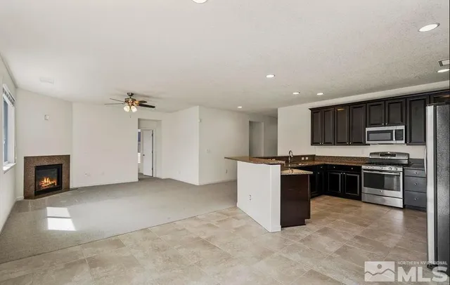 a kitchen with stainless steel appliances granite countertop a stove and a refrigerator