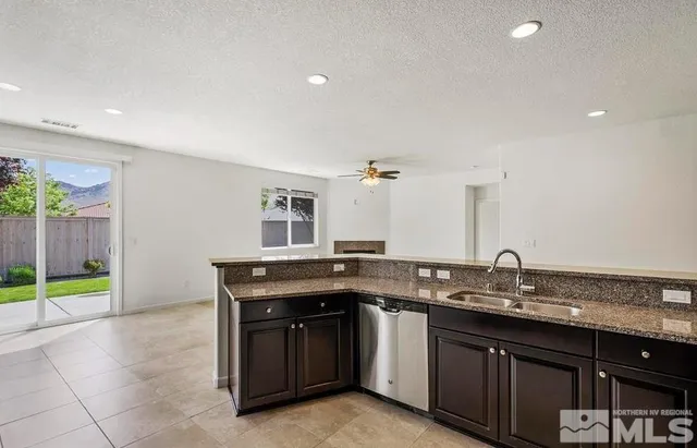 a kitchen with granite countertop a sink and cabinets