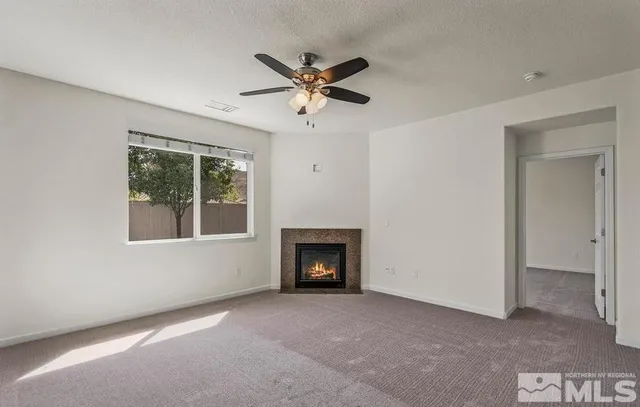 a view of a livingroom with a ceiling fan and window