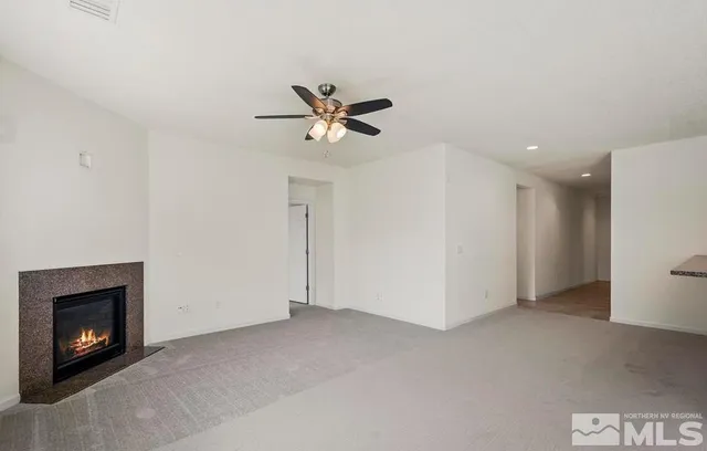 a view of an empty room with a fireplace