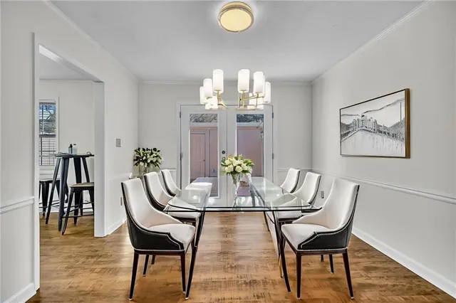 a view of a dining room with furniture and chandelier