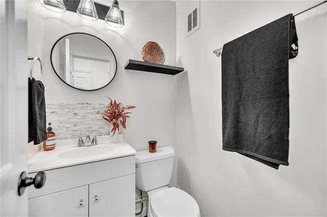 a bathroom with a sink mirror and toilet