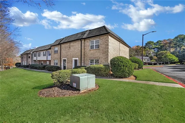 a view of a house with a yard and porch