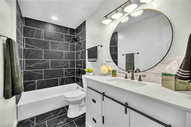 a bathroom with a sink a toilet and a mirror