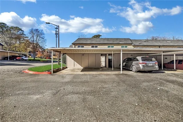 a view of a house with a yard and garage