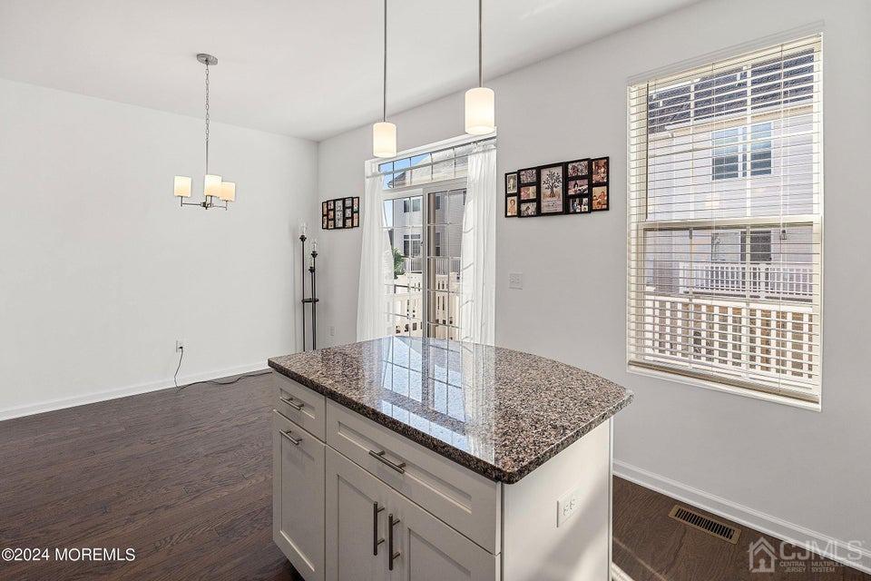 304 Discovery Road, Unit 1804 Brick, NJ 08723 - Photo 15 of 48 a kitchen with kitchen island granite countertop a stove and a white refrigerator