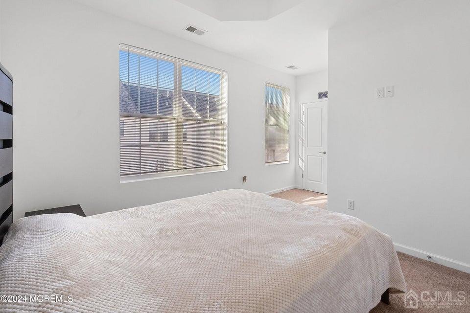 304 Discovery Road, Unit 1804 Brick, NJ 08723 - Photo 28 of 48 a large white bed in a room