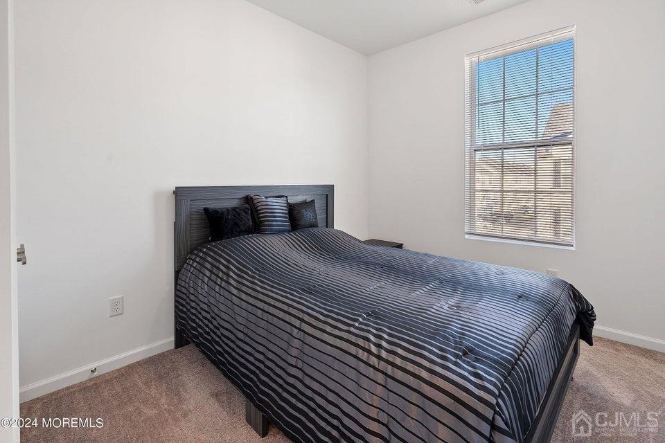 304 Discovery Road, Unit 1804 Brick, NJ 08723 - Photo 33 of 48 a bedroom with a bed and a window