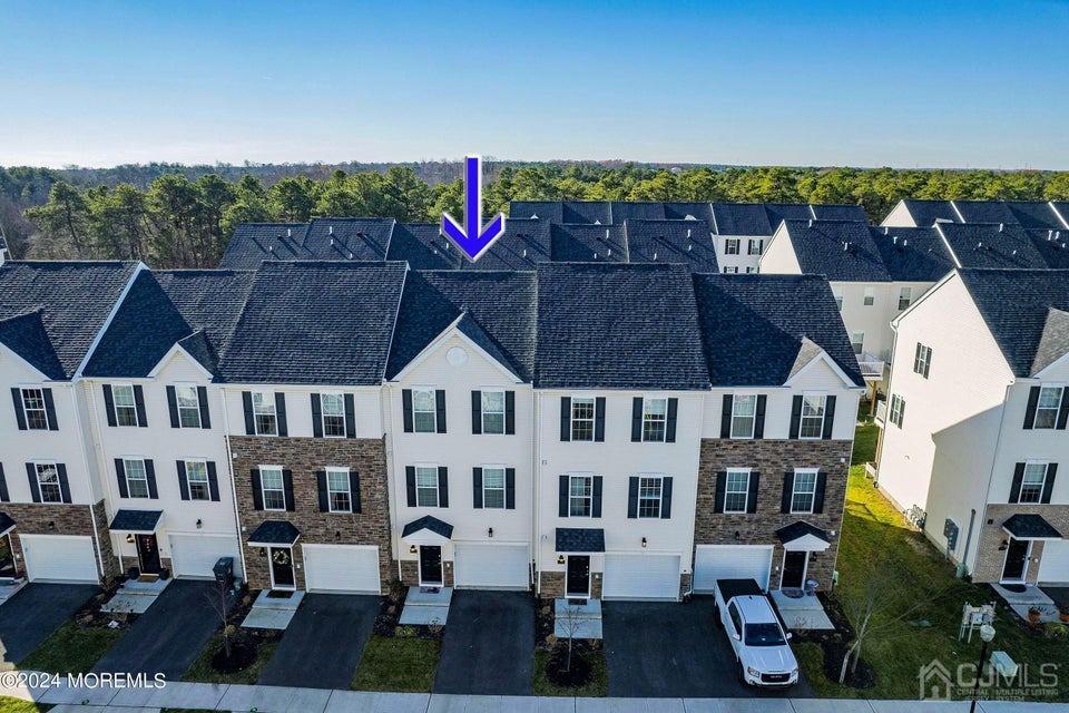 304 Discovery Road, Unit 1804 Brick, NJ 08723 - Photo 5 of 48 a view of a chairs and table on the terrace