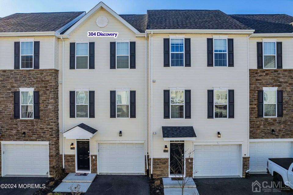 304 Discovery Road, Unit 1804 Brick, NJ 08723 - Photo 7 of 48 a front view of a house with a yard