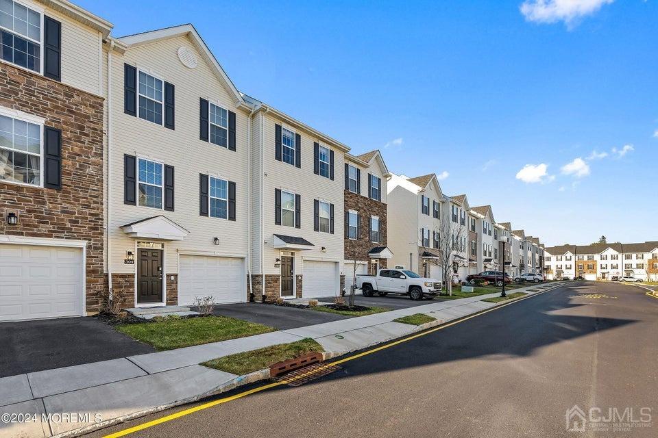 304 Discovery Road, Unit 1804 Brick, NJ 08723 - Photo 8 of 48 a view of a street in front of a building