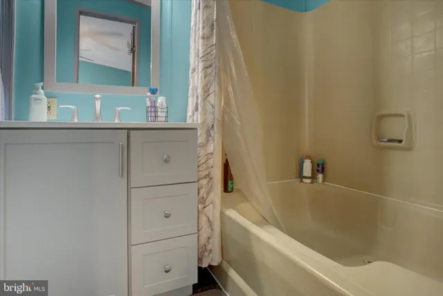 a bathroom with a bathtub and a sink