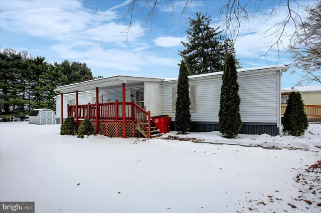 a view of a house with a yard covered in snow