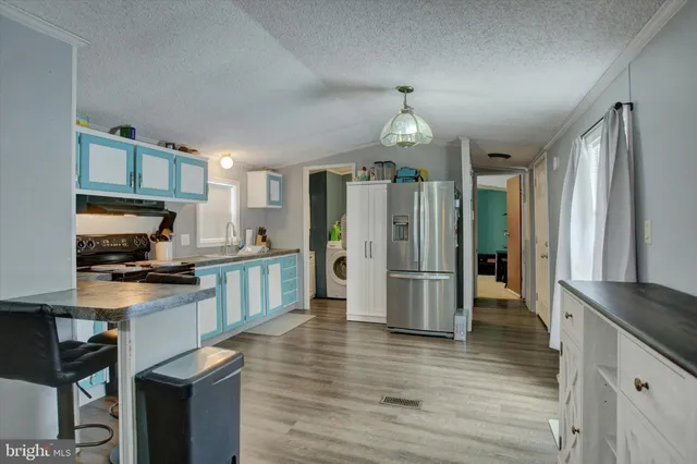 a kitchen with stainless steel appliances a refrigerator sink and microwave