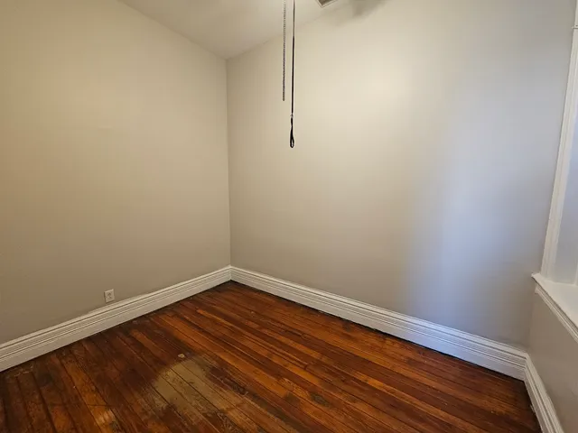 a view of room with wooden floor