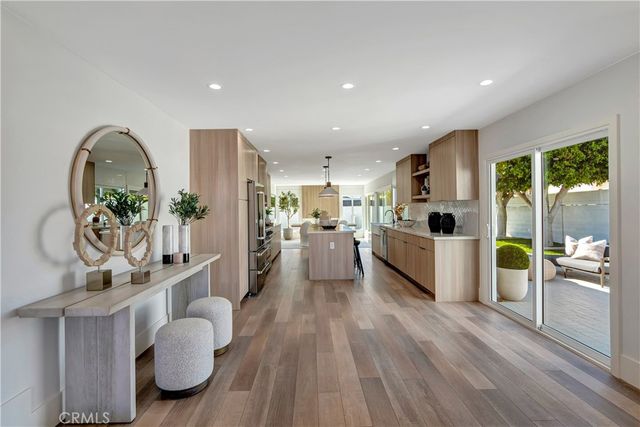 a large kitchen with stainless steel appliances granite countertop a sink stove and refrigerator